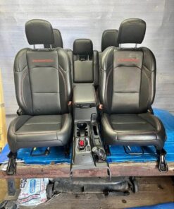 set of black leather seats with red stitching and “RUBICON” embroidered in red, which are the front and rear seats